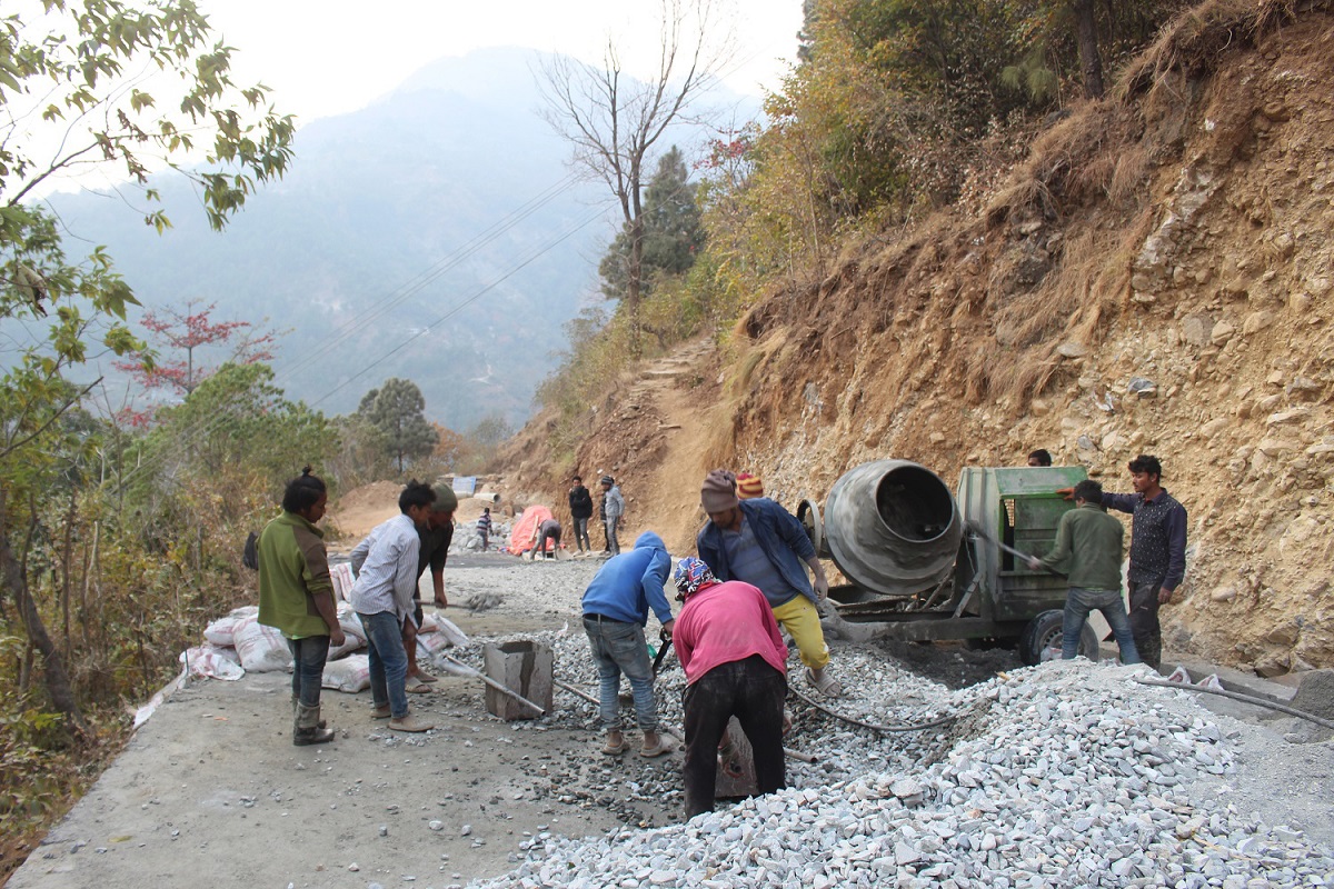 पर्वतको जलजलामा सडक ढलान गर्दै मजदुर